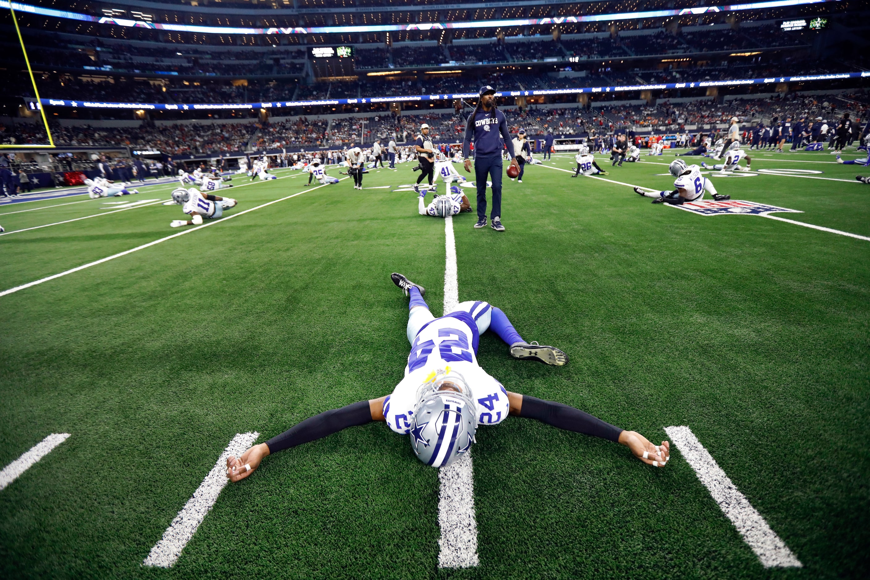 Dallas Cowboys safety Israel Mukuamu (24) stretches during pregame warmups before facing the...