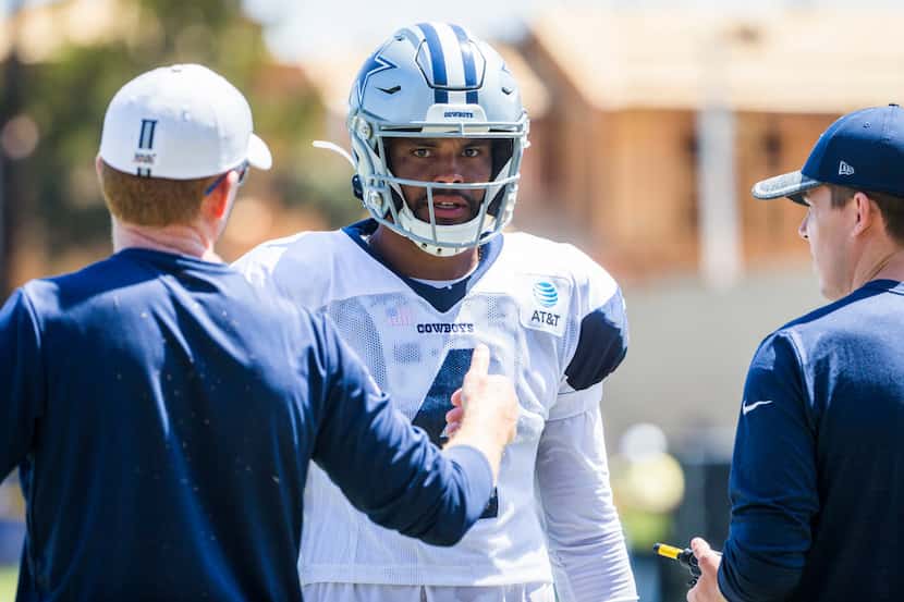 Dallas Cowboys quarterback Dak Prescott (4) talks with head coach Jason Garrett, left, and...