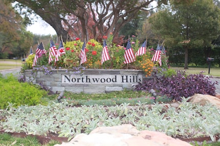 Northwood Hills neighborhood entry with landscaping and American flags.