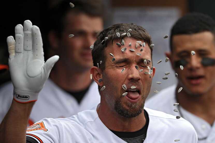BALTIMORE, MD - MAY 24: J.J. Hardy #2 of the Baltimore Orioles has sunflower seeds thrown on...