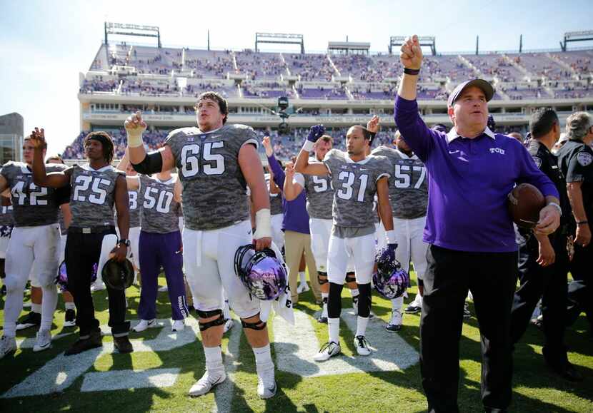 TCU head coach Gary Patterson sings the school fight song with TCU football team after the...