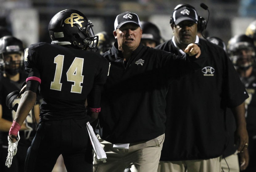 TXHSFB Royse City head coach David Petroff talks to Royse City linebacker Patrick Perry (14)...