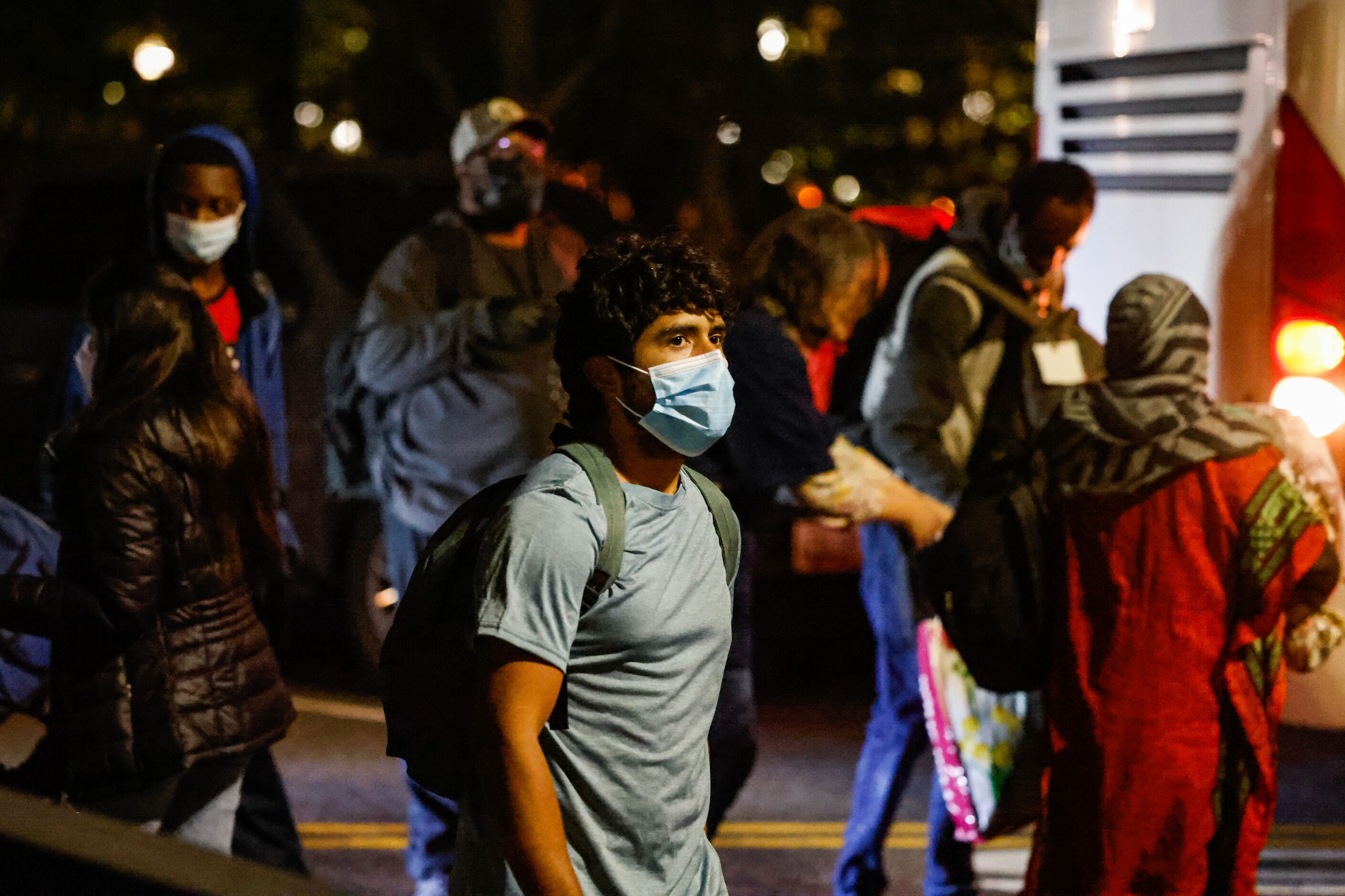 Victor Rodriguez, 26, walks at Delaware Ave NE after disembarking the bus that took him...