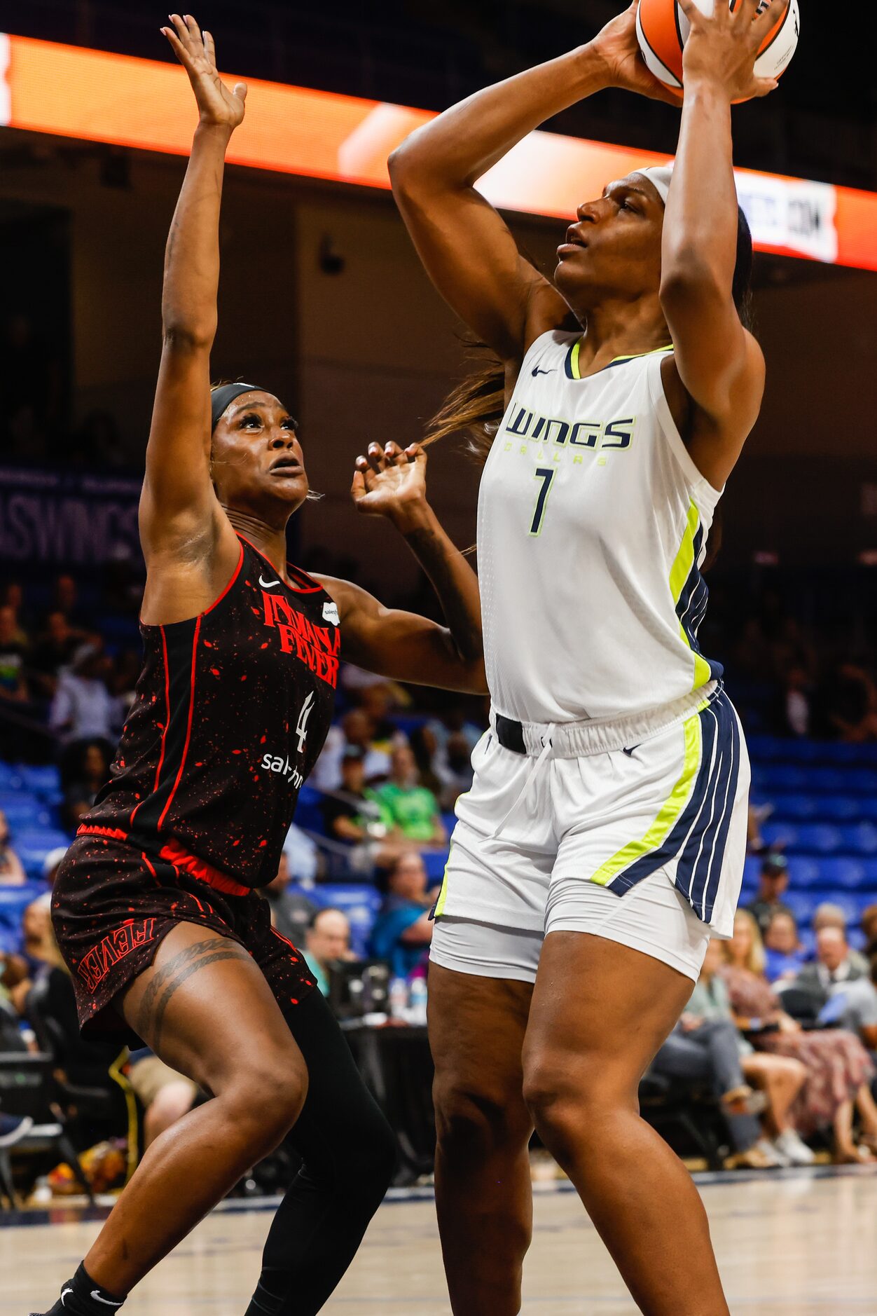 Dallas Wings center Teaira McCowan (7) goes for a shot as Indiana Fever center Queen Egbo...