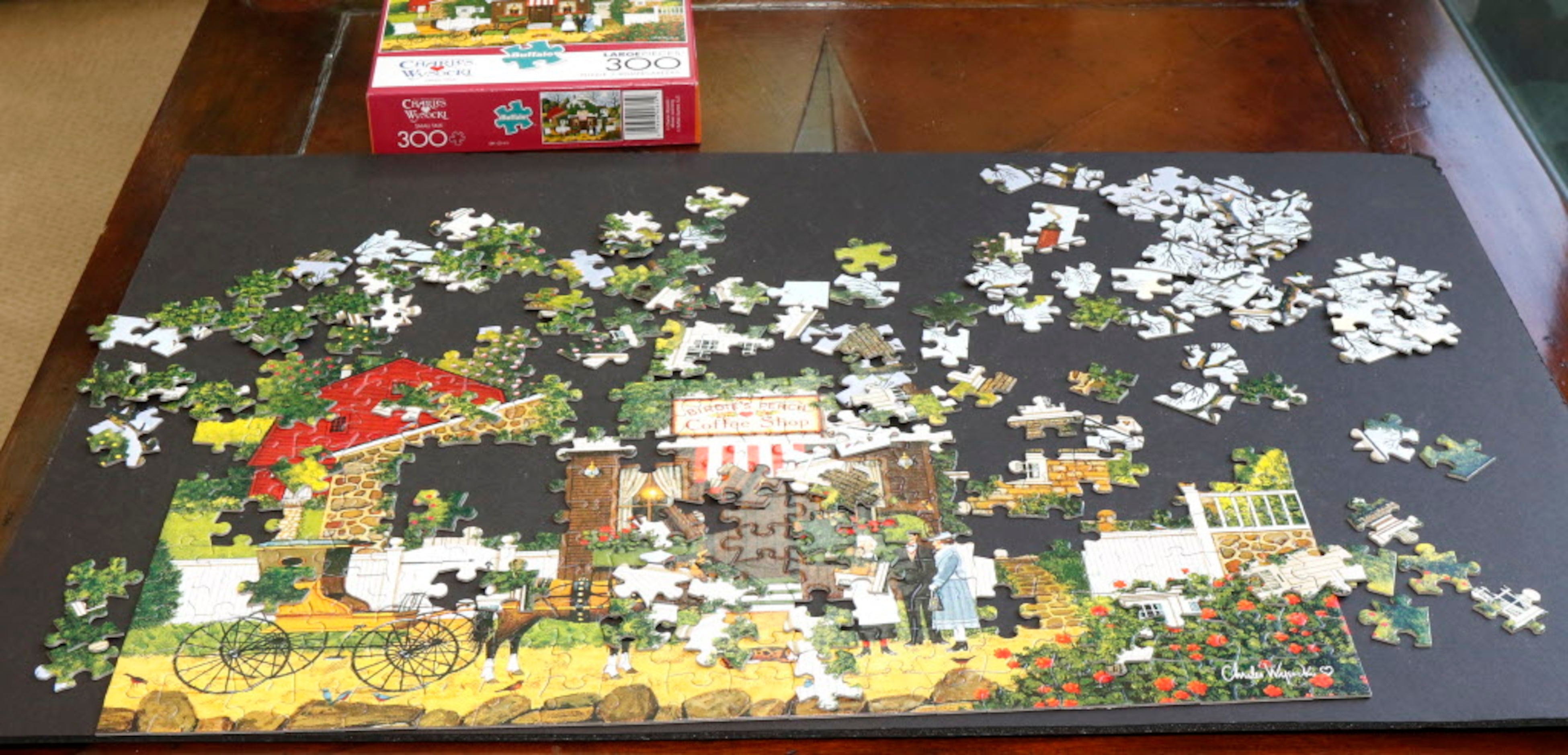 The Smith family is currently working on a jigsaw puzzle in the family room in the home of...