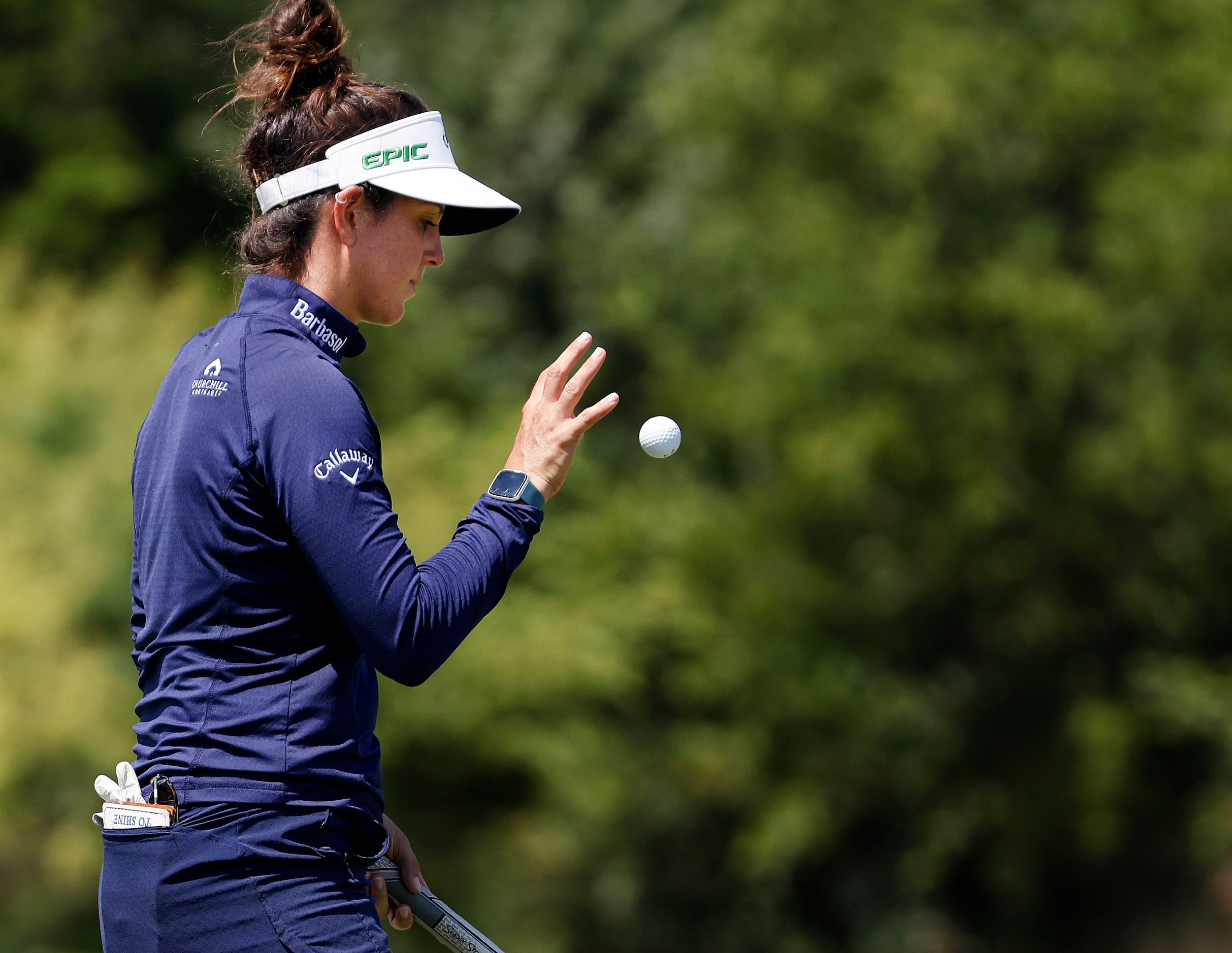 Professional golfer Emma Talley flips her ball after saving par on No. 17 during the opening...