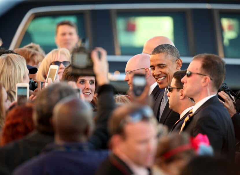 President Barack Obama greets with selected guest in a en after arriving at Love Field  in...