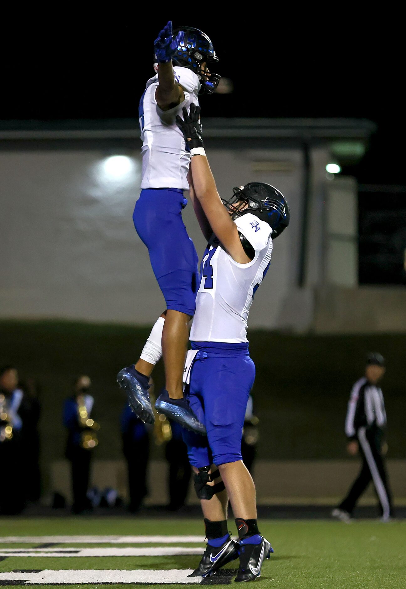 Byron Nelson offensive lineman Auston Martinez (54) holds up wide receiver Landon...