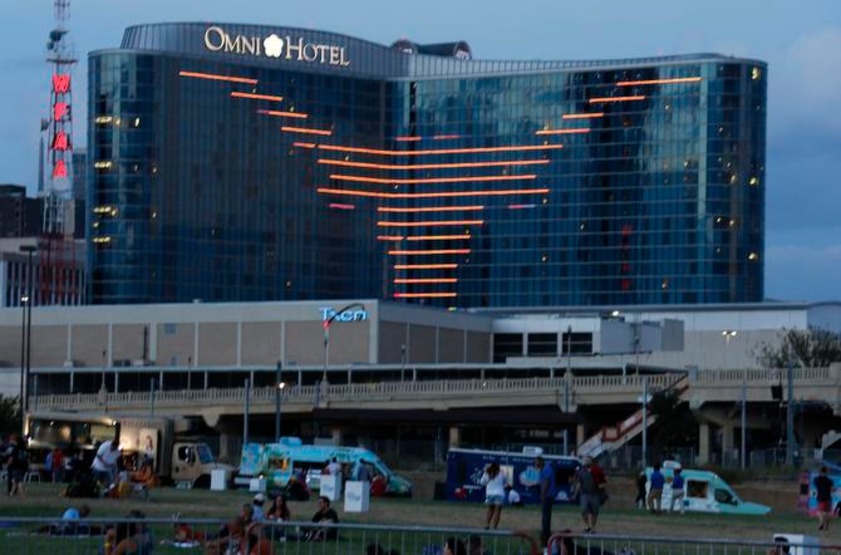 
The Omni Hotel displays the University of Texas logo as fans gather for a fireworks display...