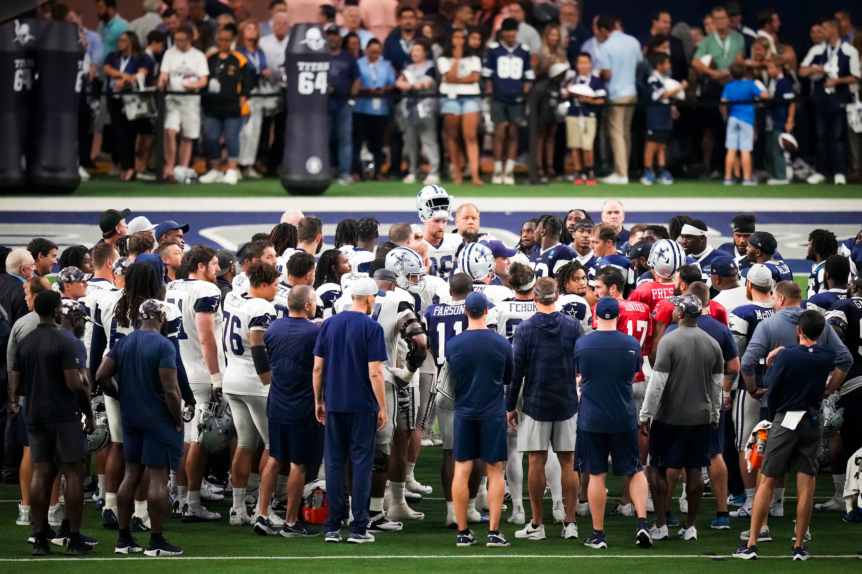 Dallas Cowboys players gather around head coach Mike McCarthy at the conclusion of a...