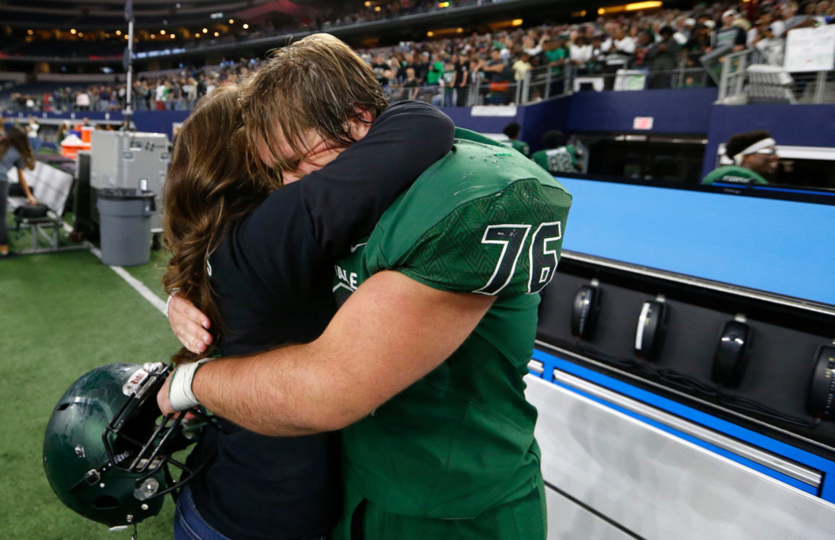 Kennedale's Brett Bostad (76) gets a hug from his mother Patti Bostad after defeating...