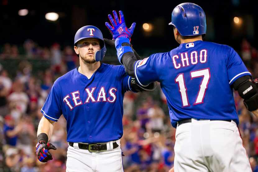 Texas Rangers left fielder Ryan Rua celebrates with right fielder Shin-Soo Choo after...