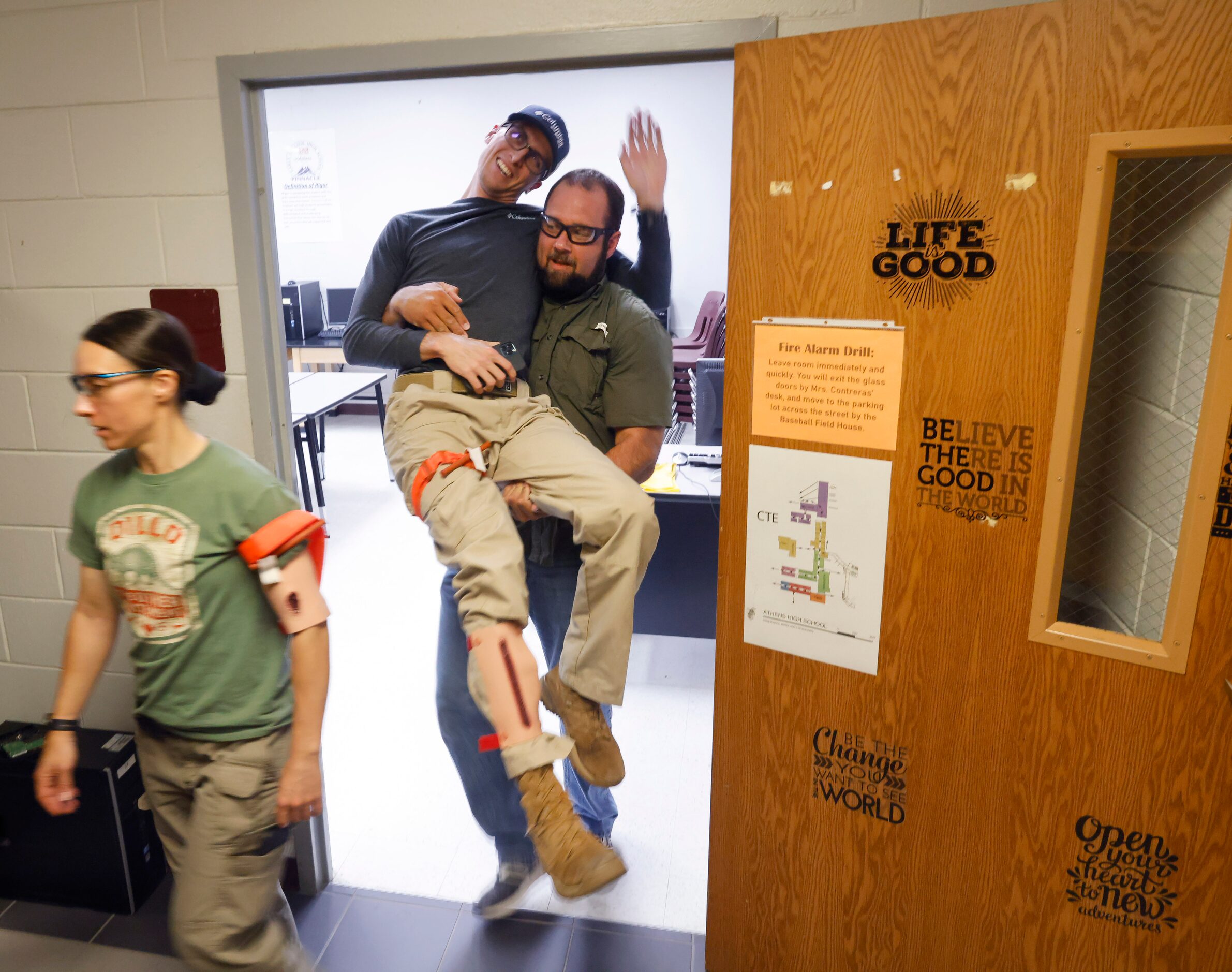 Henderson County Sheriff’s Deputy Cody Baker tries to keep from banging his head on a...