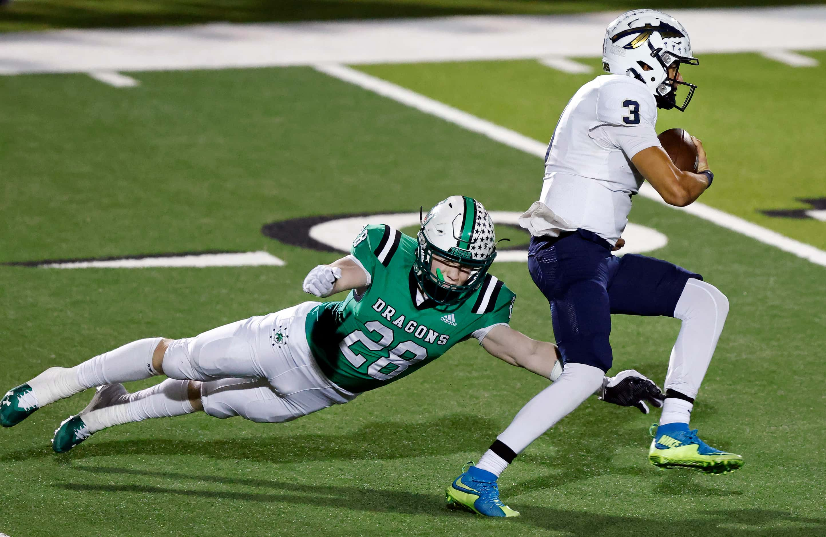 Southlake Carroll linebacker Aaron Scherp (28) makes a diving tackle attempt of Keller...