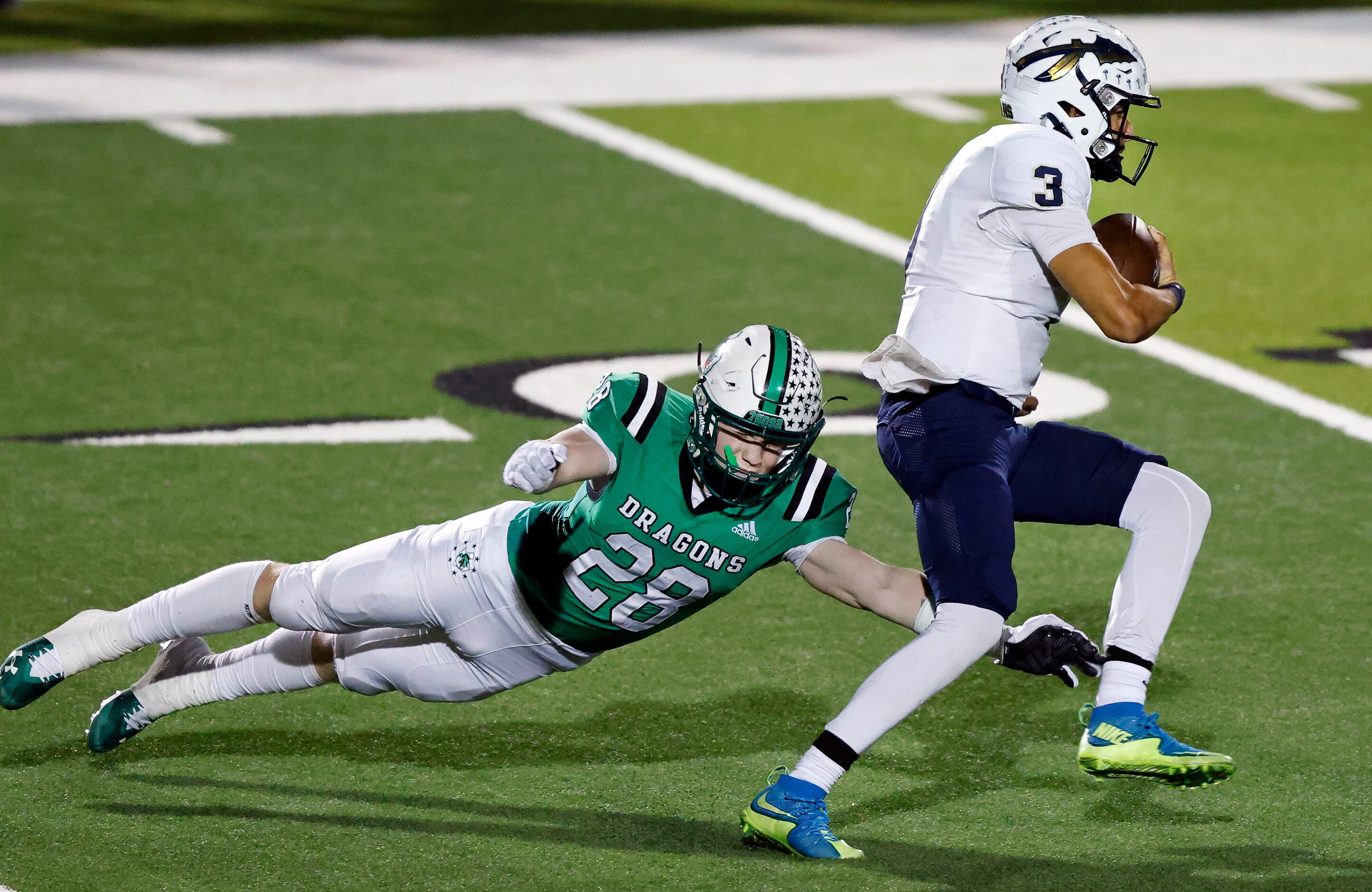 Southlake Carroll linebacker Aaron Scherp (28) makes a diving tackle attempt of Keller...