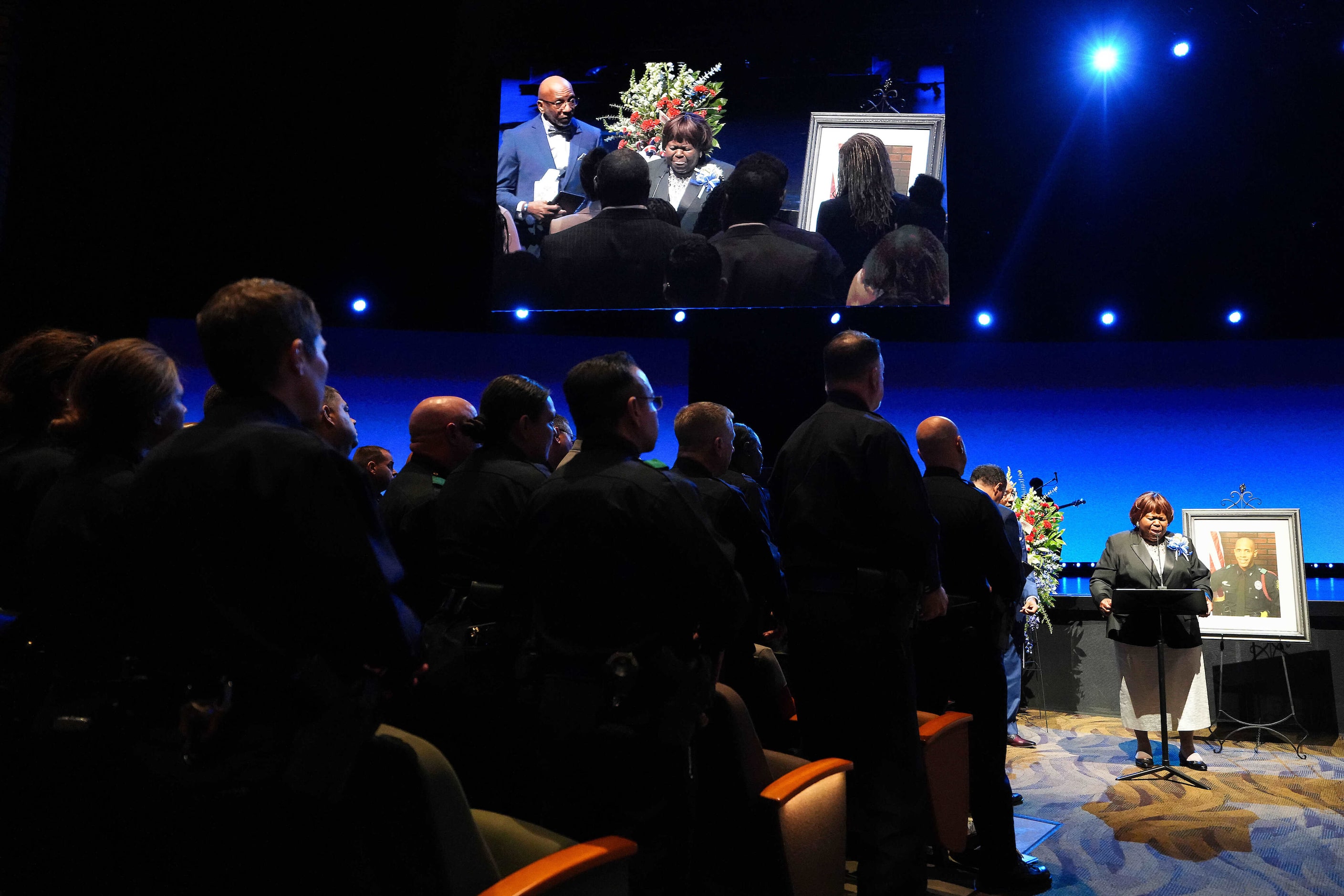 Dallas police command staff stand as Cherie Jeffery speaks during funeral services for her...