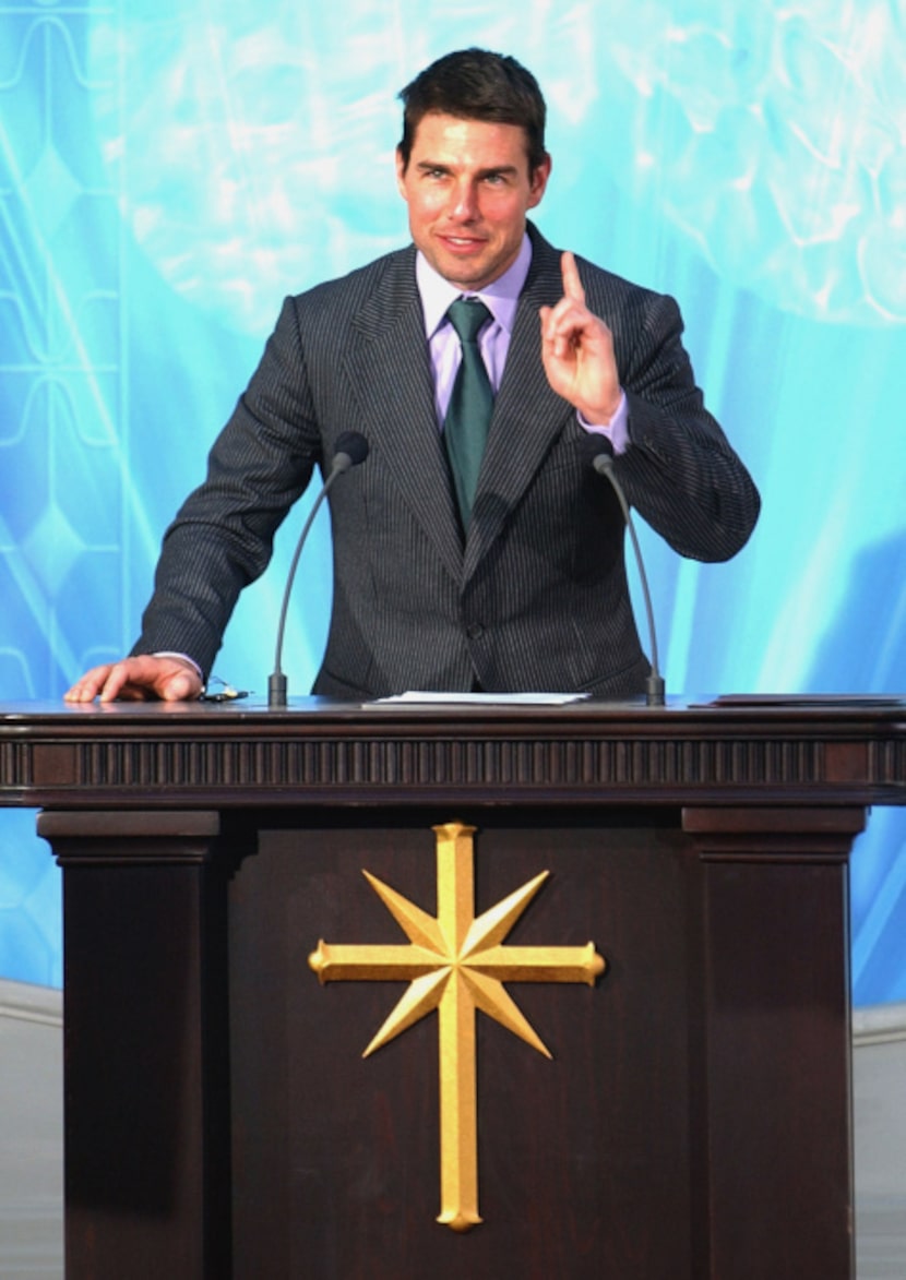 Actor Tom Cruise gestures while making a speech during the official opening of a new...