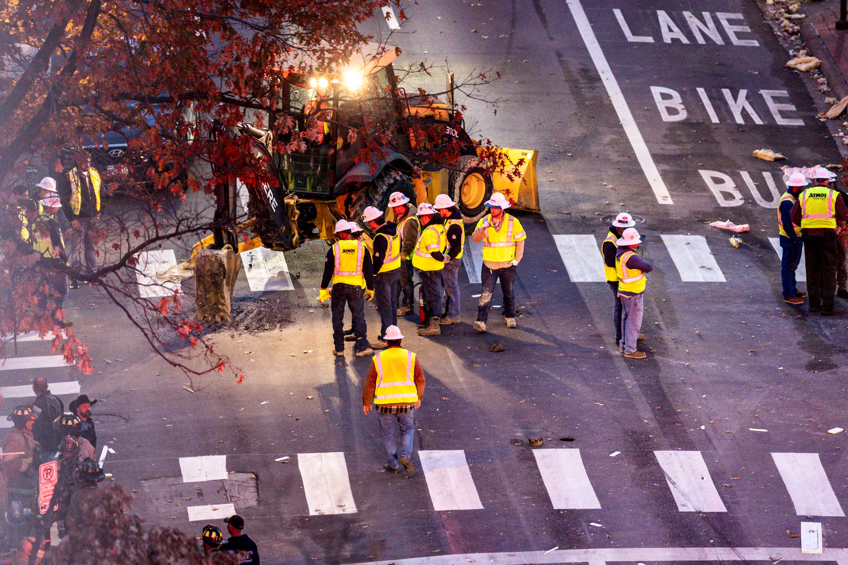 Atmos Energy employees are seen supervising the excavation of the intersection of Houston...