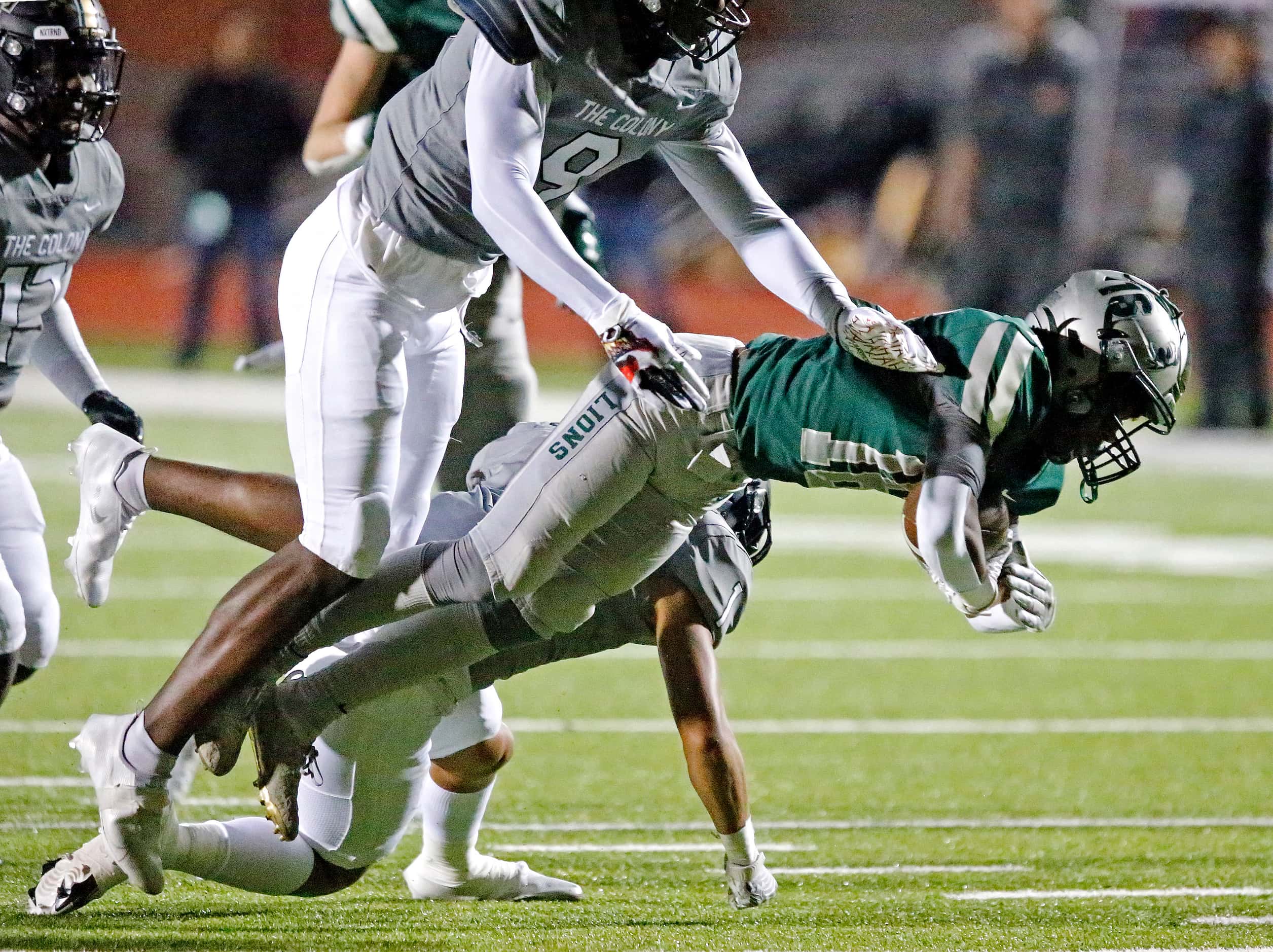 Frisco Reedy High School wide receiver Devin Hardy (16) is knocked off his feet by The...
