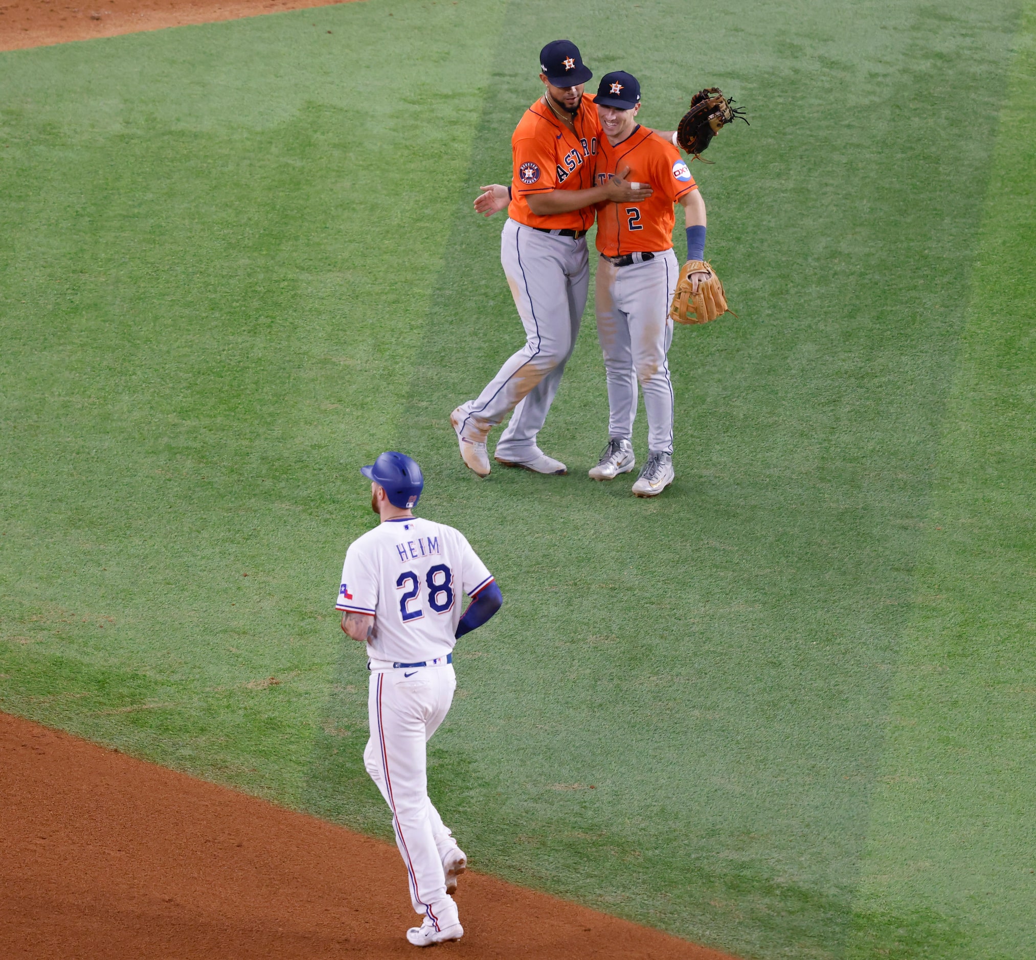 Texas Rangers catcher Jonah Heim walks off the field as Houston Astros first baseman Jose...