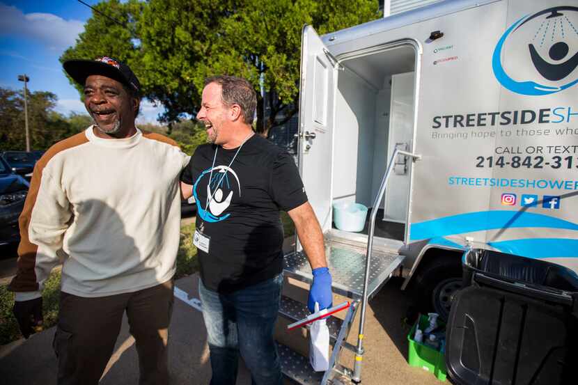 Lance Olinski (right) of Streetside Showers, a program serving the homeless, shared a laugh...