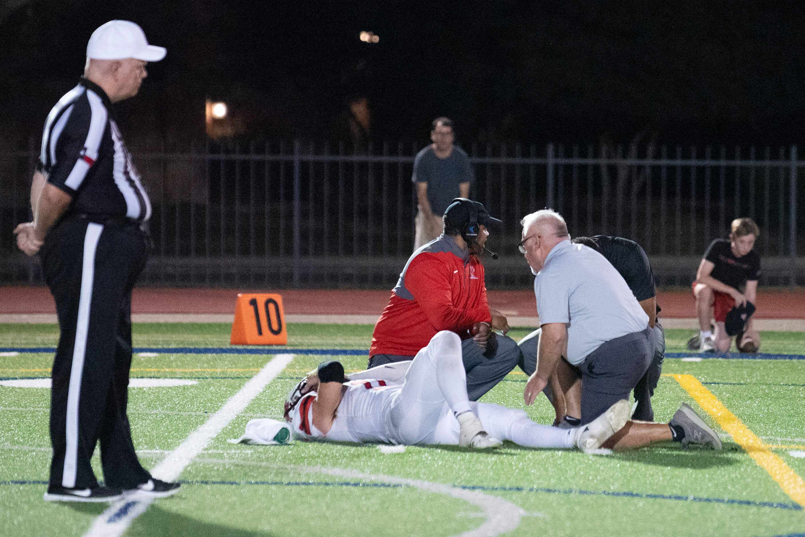 Houston St. Johns senior quarterback John Perdue (11) lies flat on his back after a hit as...