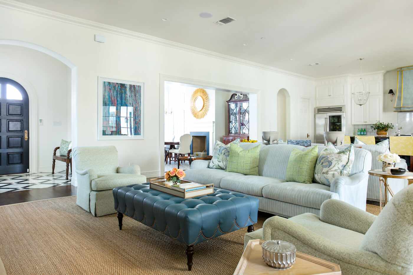 A living room features as seating area with a couch and two chairs.