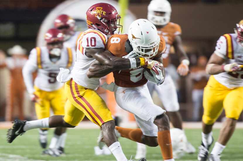Texas' Dorian Leonard (8) fights for yardage against Iowa State's Brian Peavy during the...
