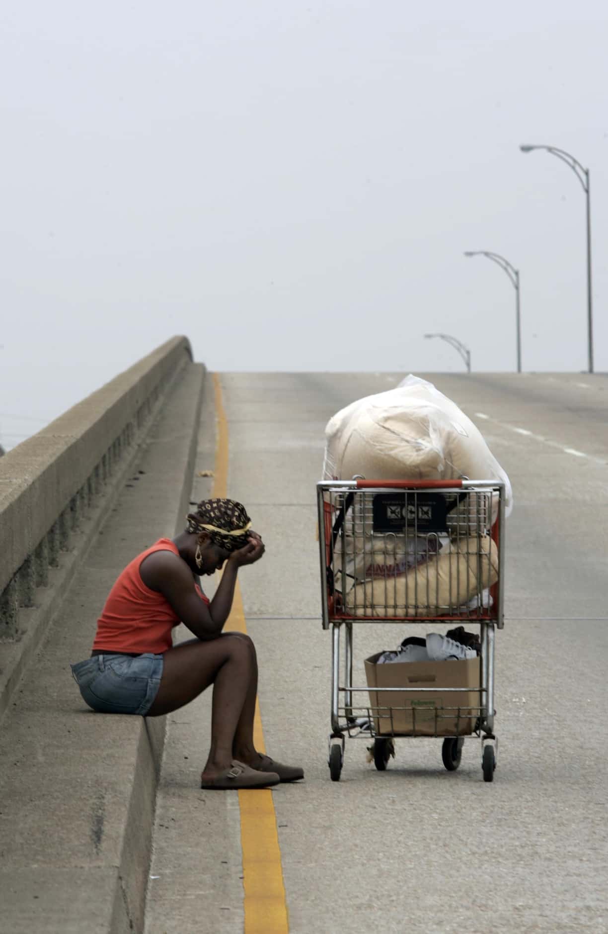 Kimi Seymour, 27, took a break from pushing her few remaining possessions along Interstate 10. 