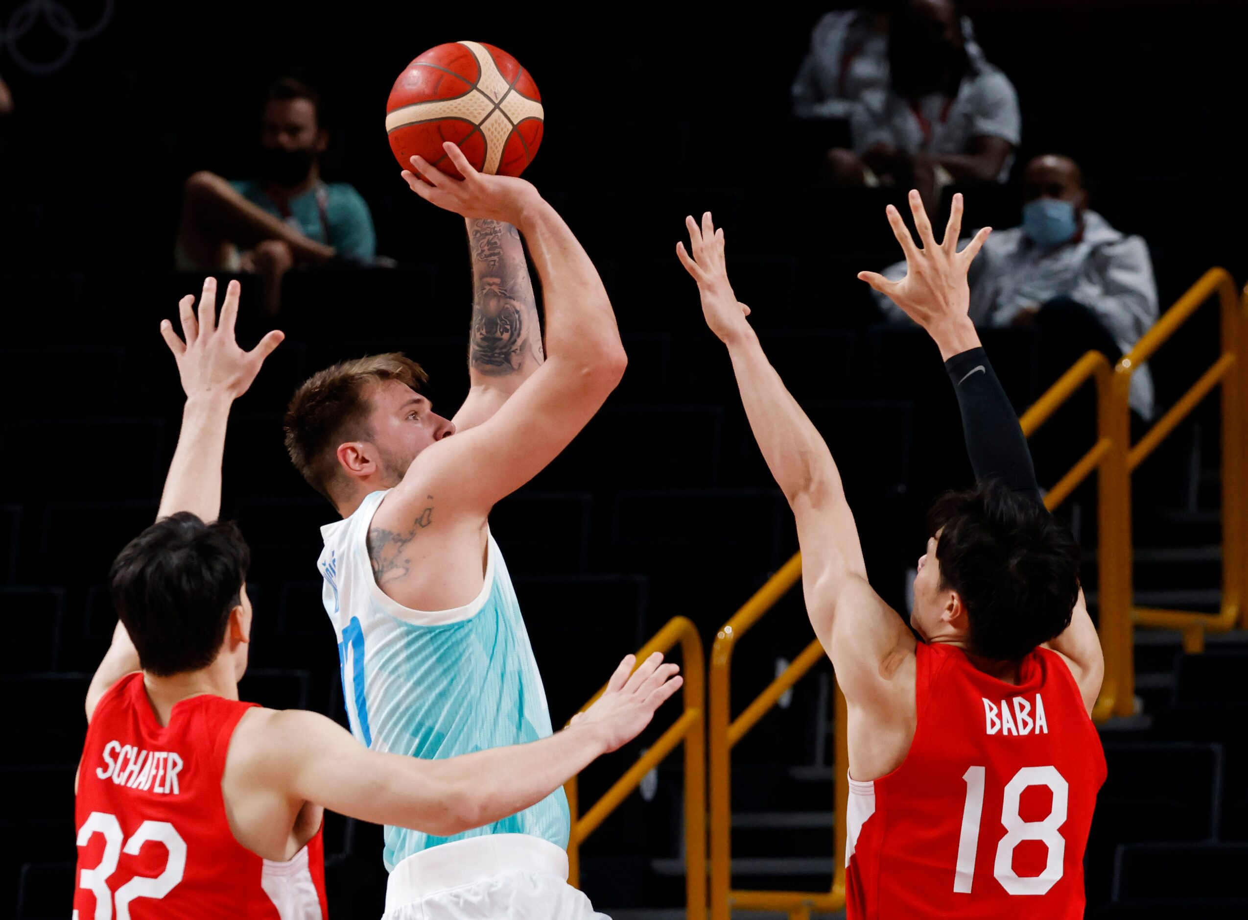 Slovenia’s Luka Doncic takes a shot in between Japan’s Avi Koki Schafer (32) and Yudai Baba...