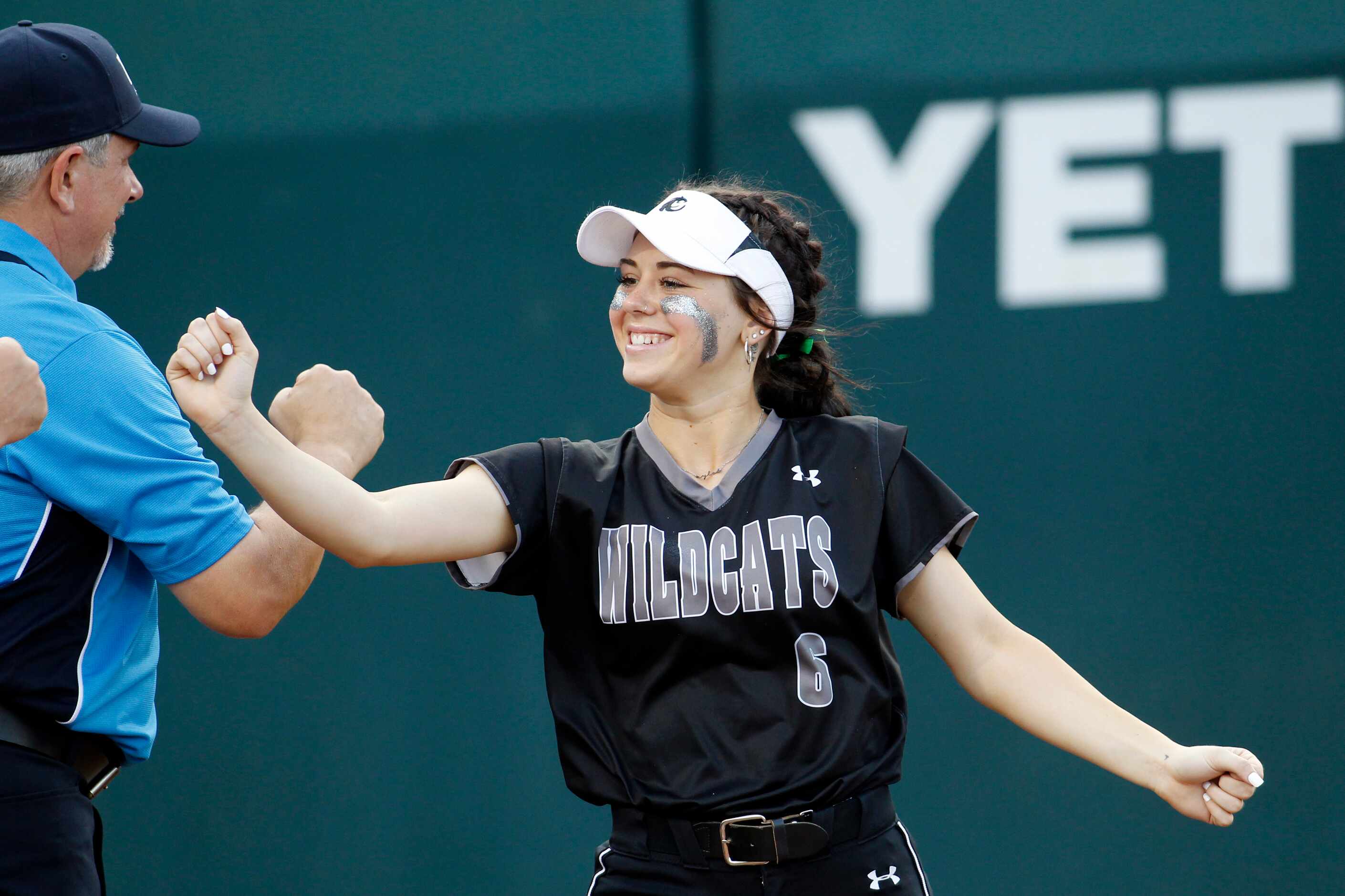 Denton Guyer's Kaylynn Jones (6) exchanges fist bumps with game officials prior to the start...