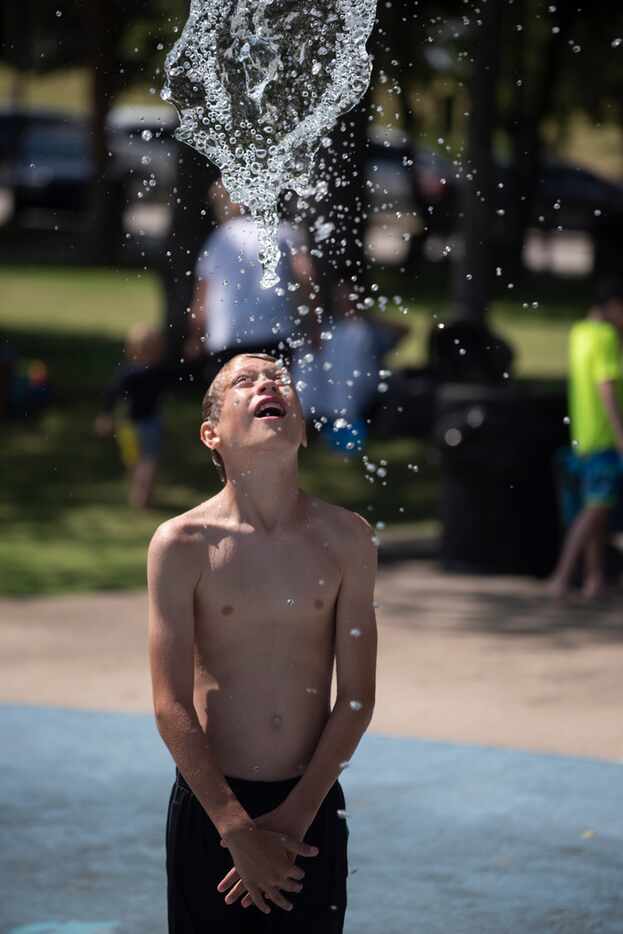 Andrew Hesser plays in the sprayground at Harry Myers Park in Rockwall.