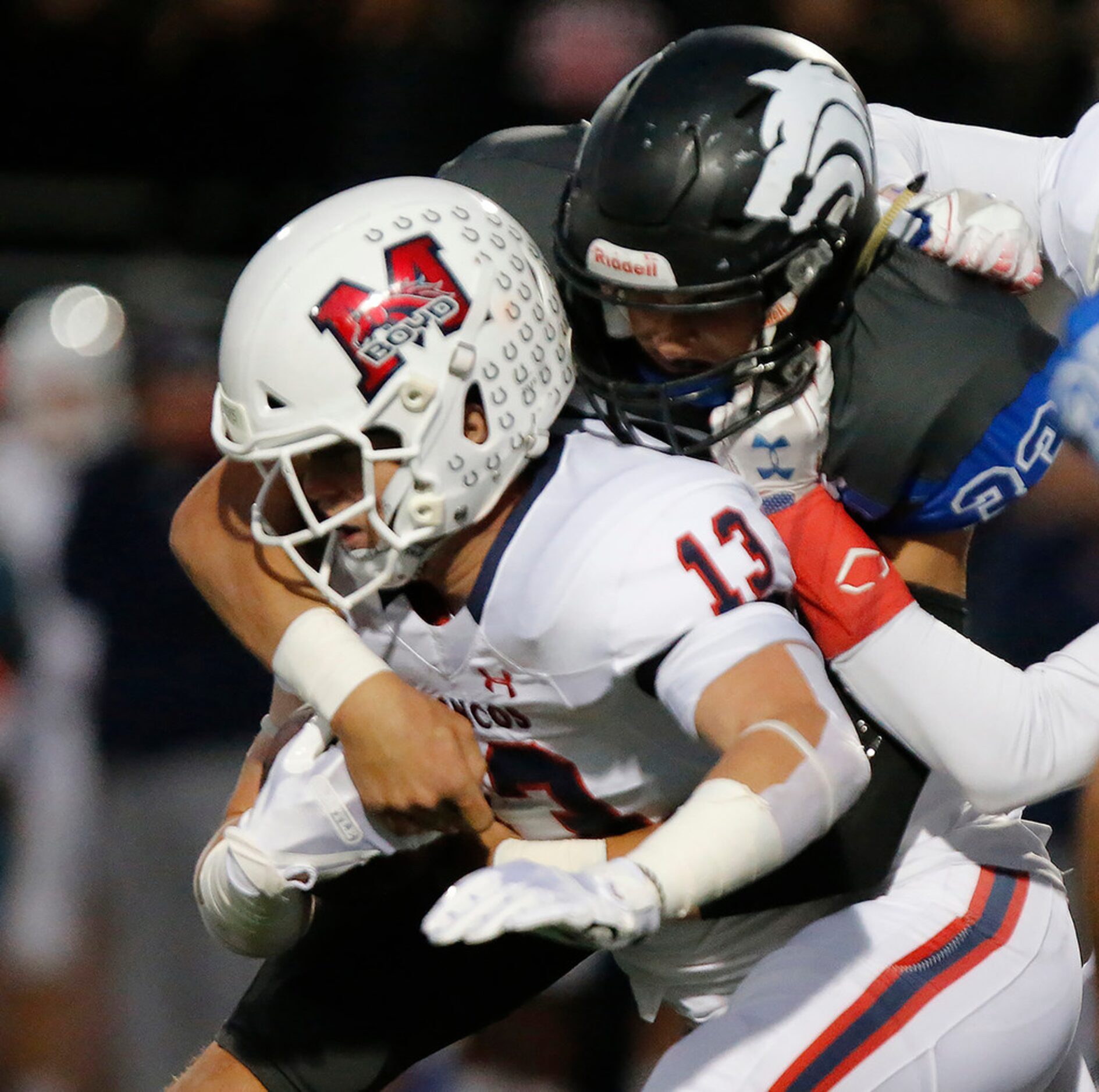 McKinney Boyd High School running back Jake Fex (13) is tackled by Plano West High School...