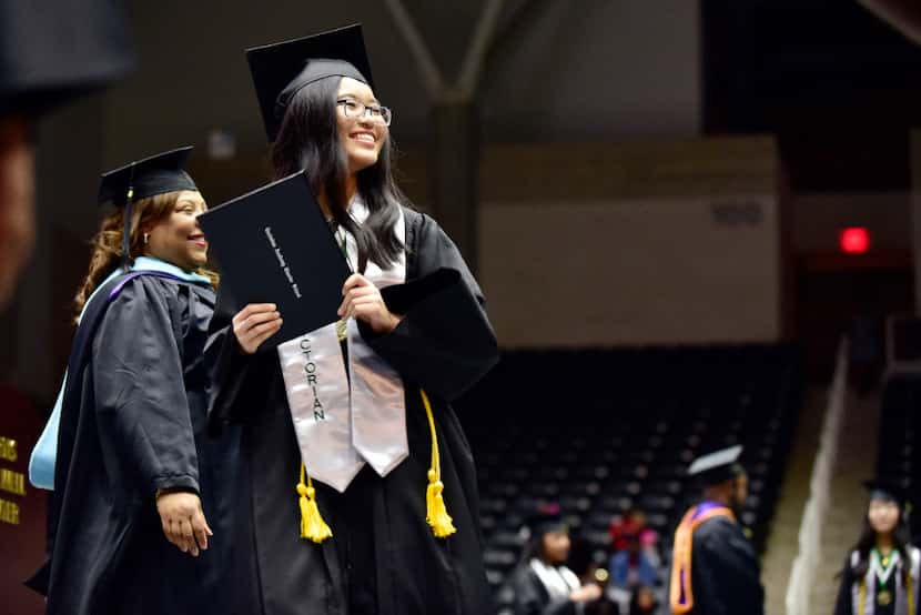Valedictorian Tran Bao Tran smiled at her family as she received her diploma during...