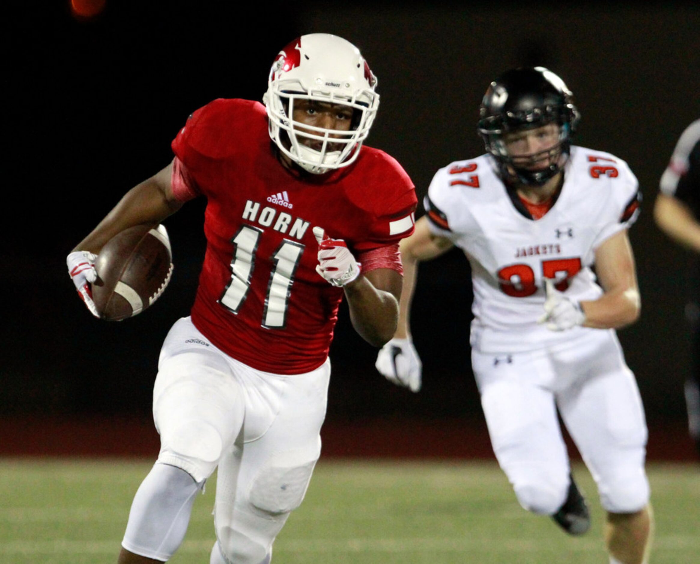 Mesquite Horn's Reagan Nickerson (11) advances a reception, as Rockwall defender Tyler...