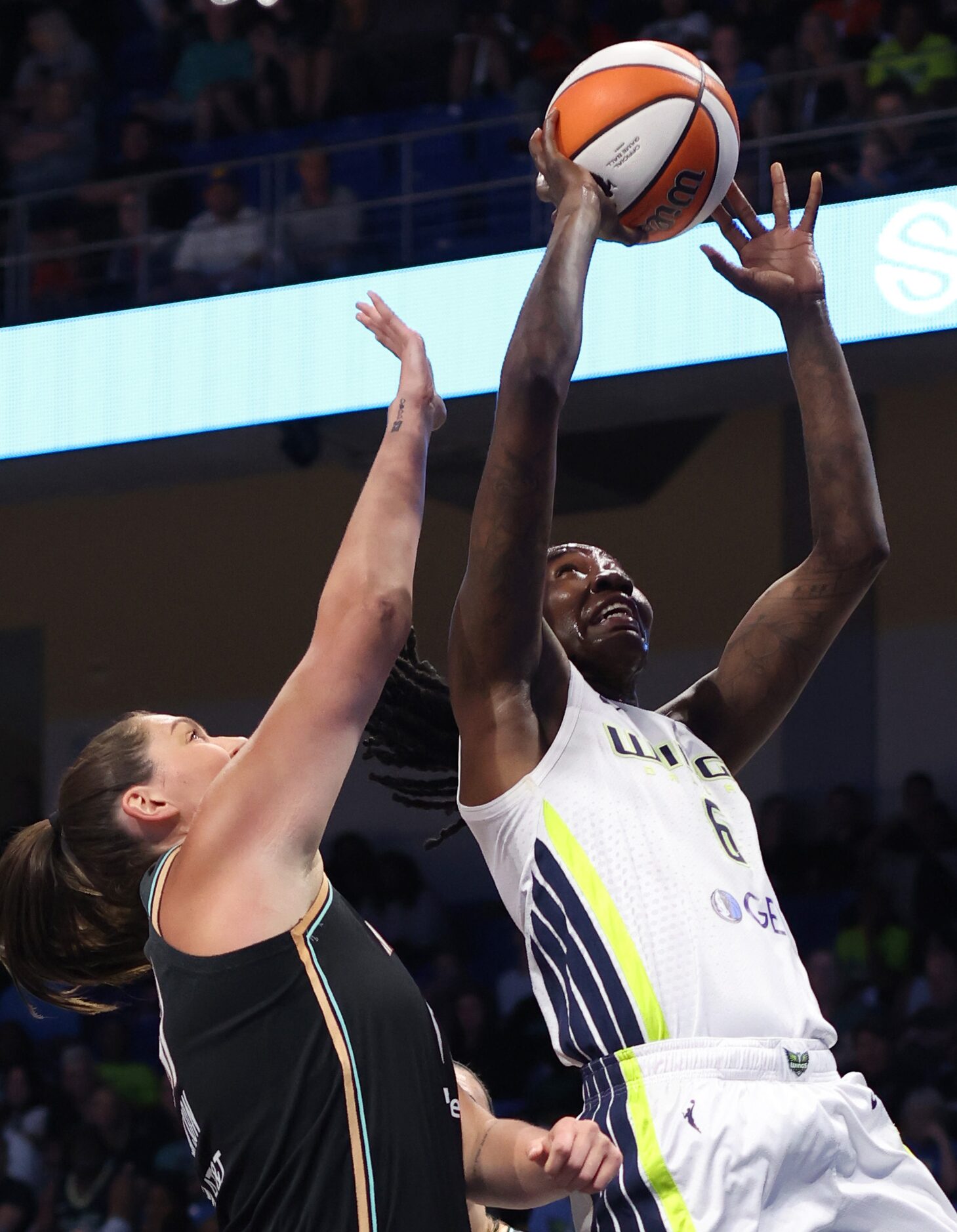 Dallas Wings forward Natasha Howard (6) shoots as she is defended by New York Liberty center...