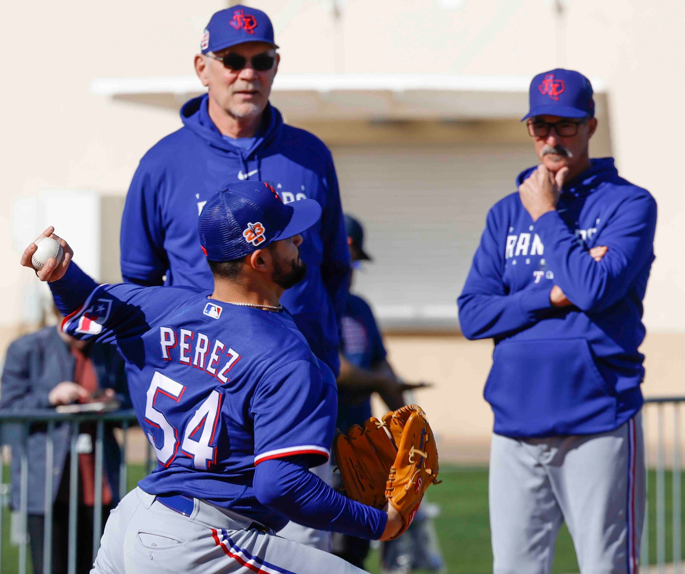 Texas Rangers manager Bruce Bochy, back left, and pitching coach Mike Maddux, right,...