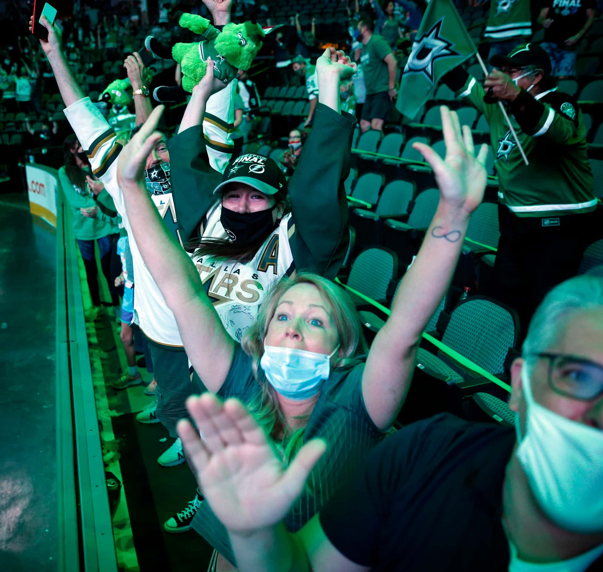 During a watch party at the American Airlines Center, Dallas Stars fans (from right) Peter...