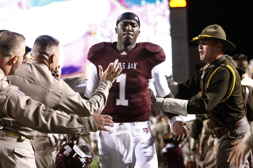 Texas A&M Aggies quarterback Jerrod Johnson (1) slaps hands with the Cadet Corps  as he is...