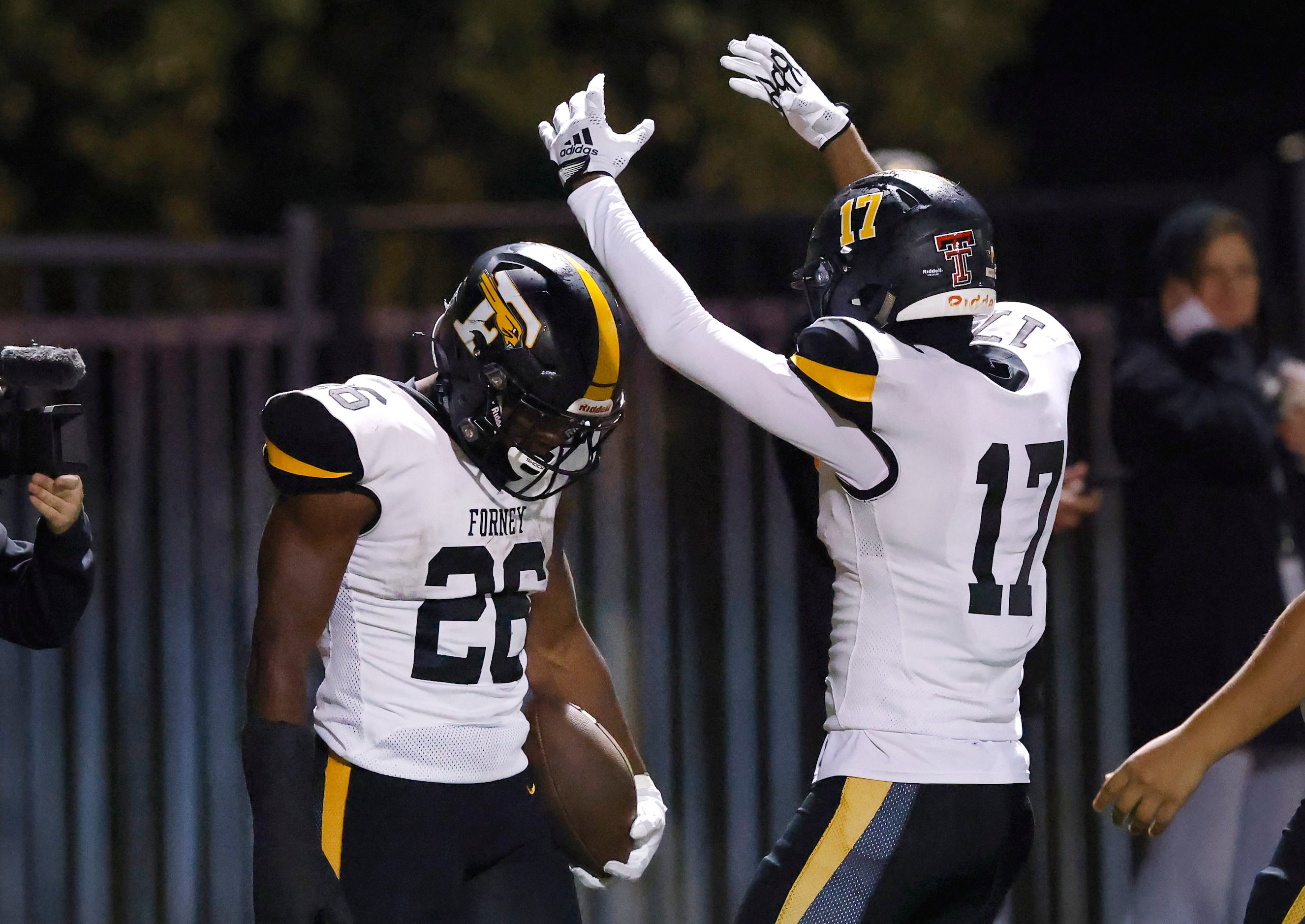 Forney running back Javian Osborne  (26) is crowned by teammate Calvin Smith (17 after...