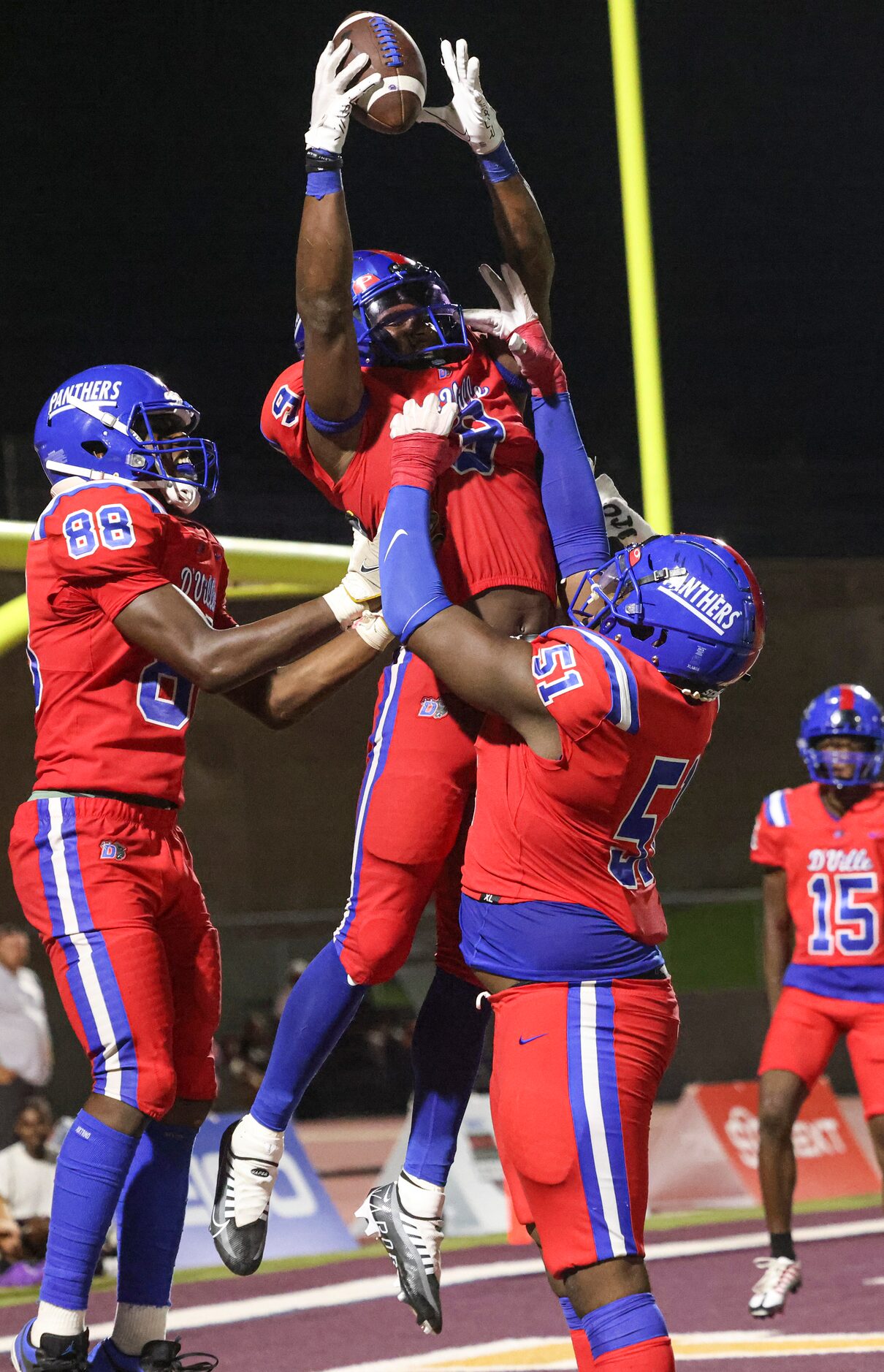 Duncanville High School Jerrale Powers (9) is hoisted in the air by Duncanville High School...