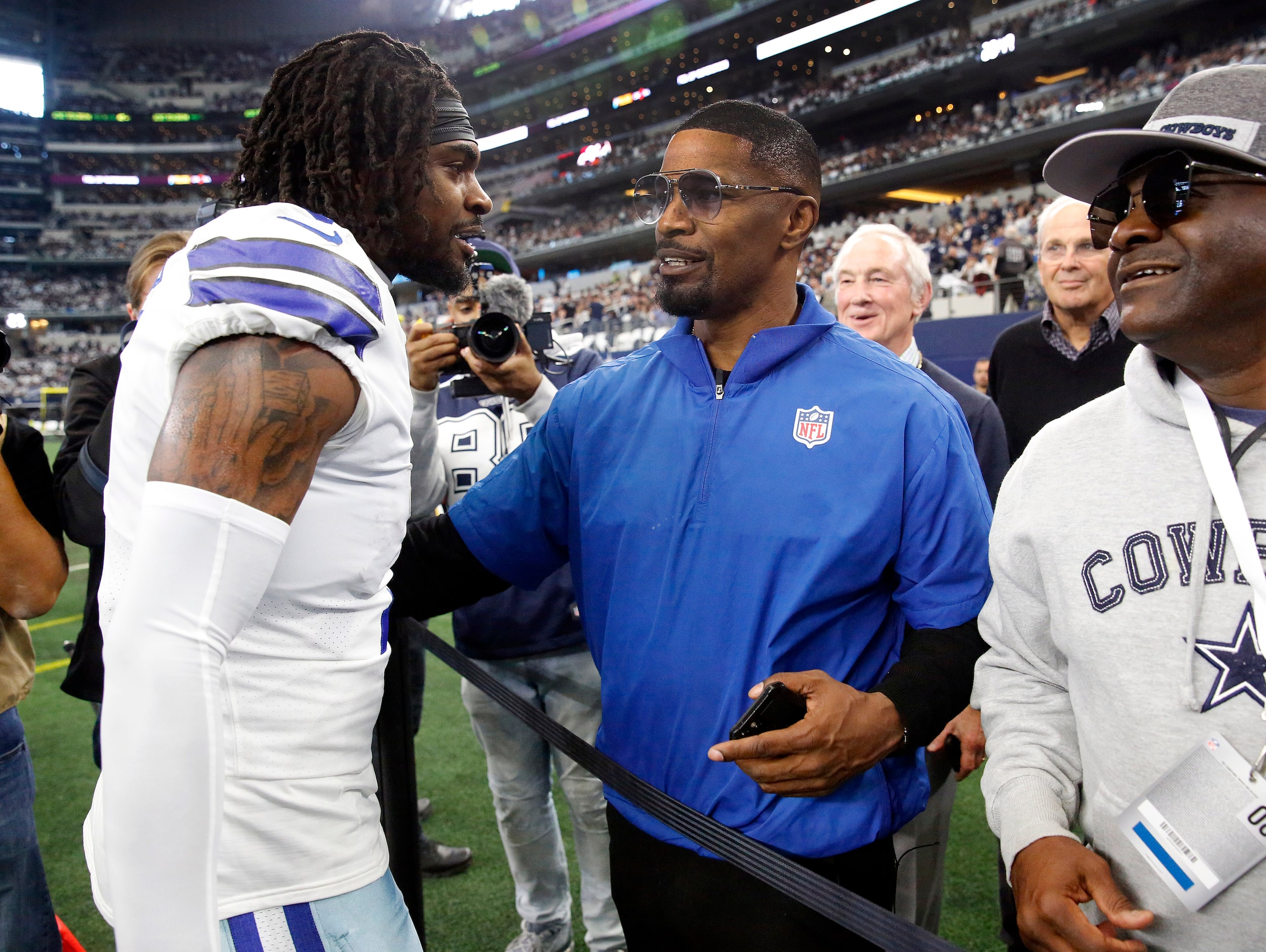 Actor Jamie Foxx (right) visits with Dallas Cowboys Trevon Diggs (7) during pregame warmups...