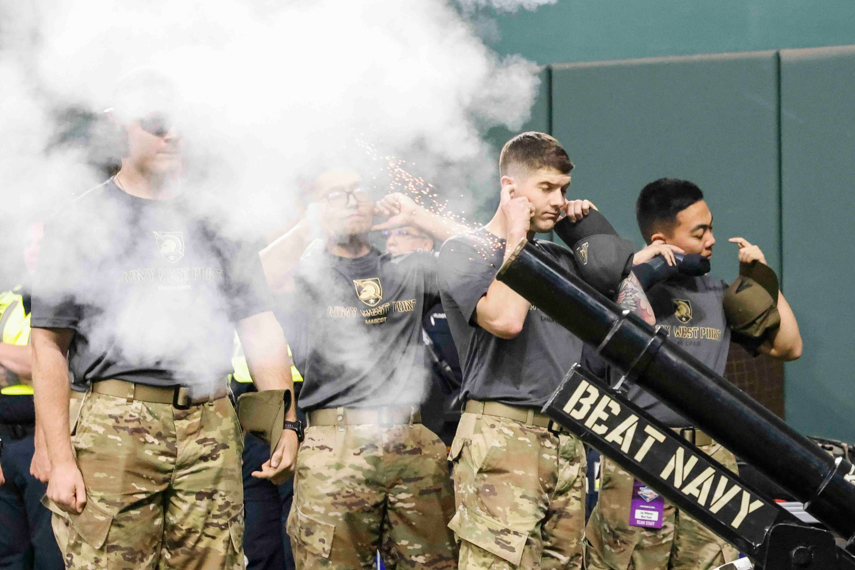 Army cadets cover their ears during a cannon blow up as Air Force celebrate their win...