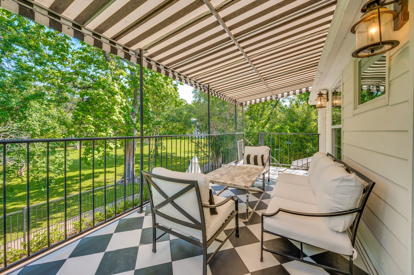 Upstairs patio with striped awning, checkerboard floors