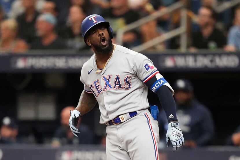 Texas Rangers right fielder Adolis Garcia celebrates after hitting a solo home run during...