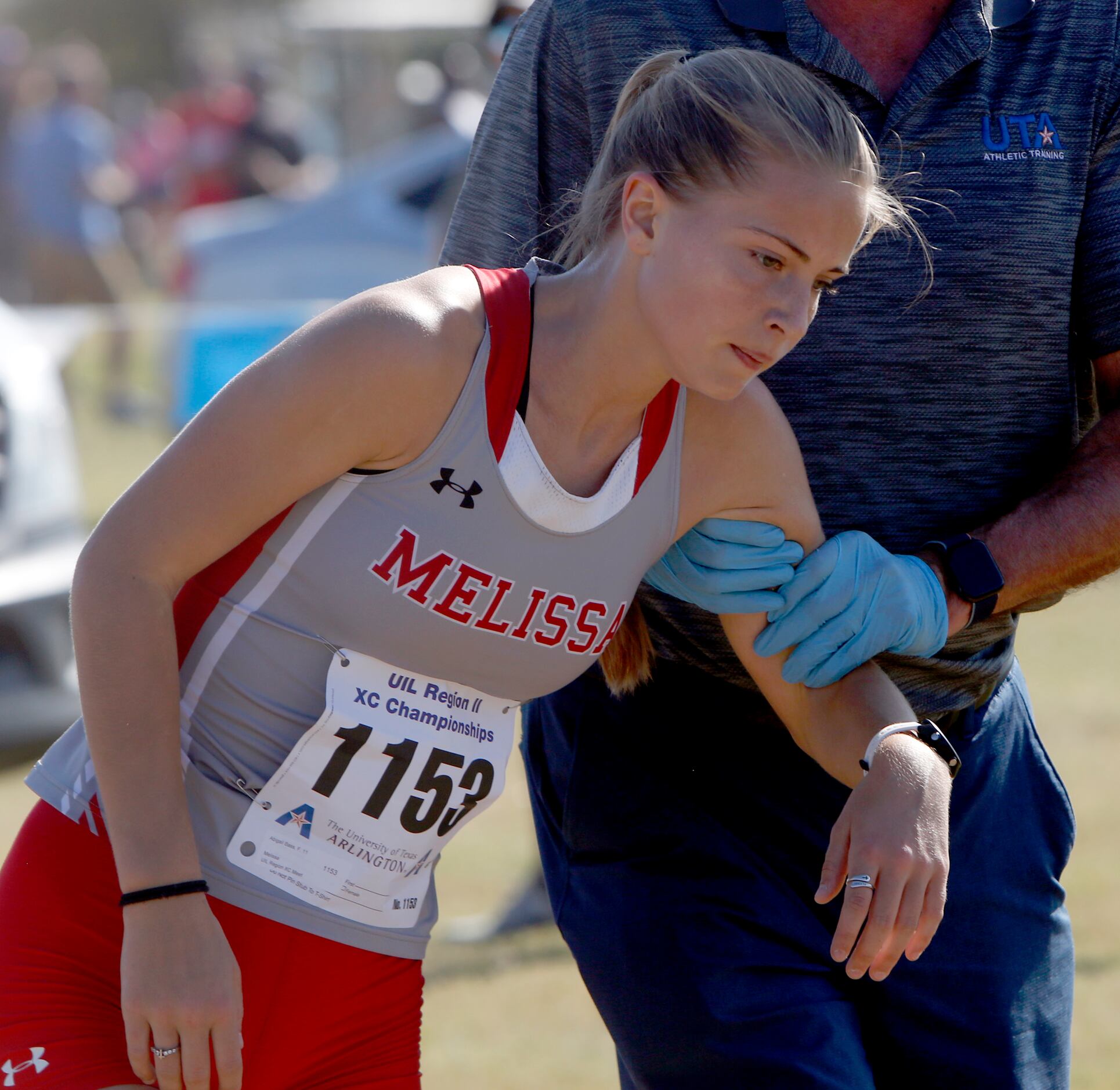 Melissa's Abigail Bass receives assistance briefly following her first place finish with a...