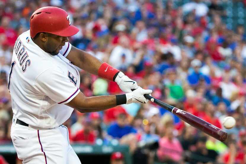 Texas Rangers shortstop Elvis Andrus connects for a single during the second inning against...