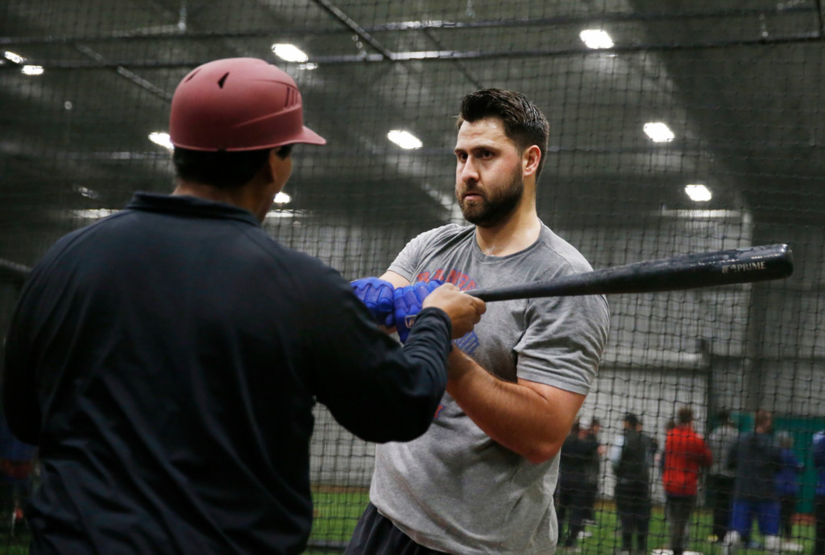 Texas Rangers Joey Gallo (13) works with Texas Rangers hitting coach Luis Ortiz (18) in the...