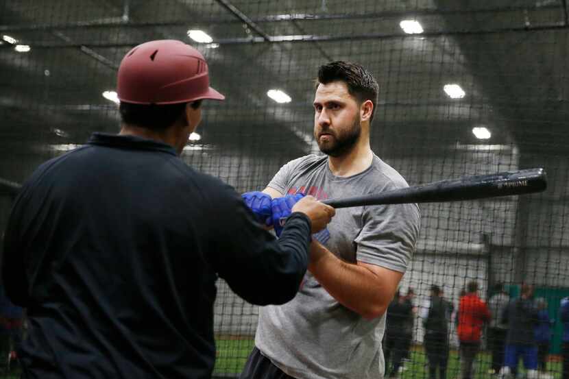 Texas Rangers Joey Gallo (13) works with Texas Rangers hitting coach Luis Ortiz (18) in the...