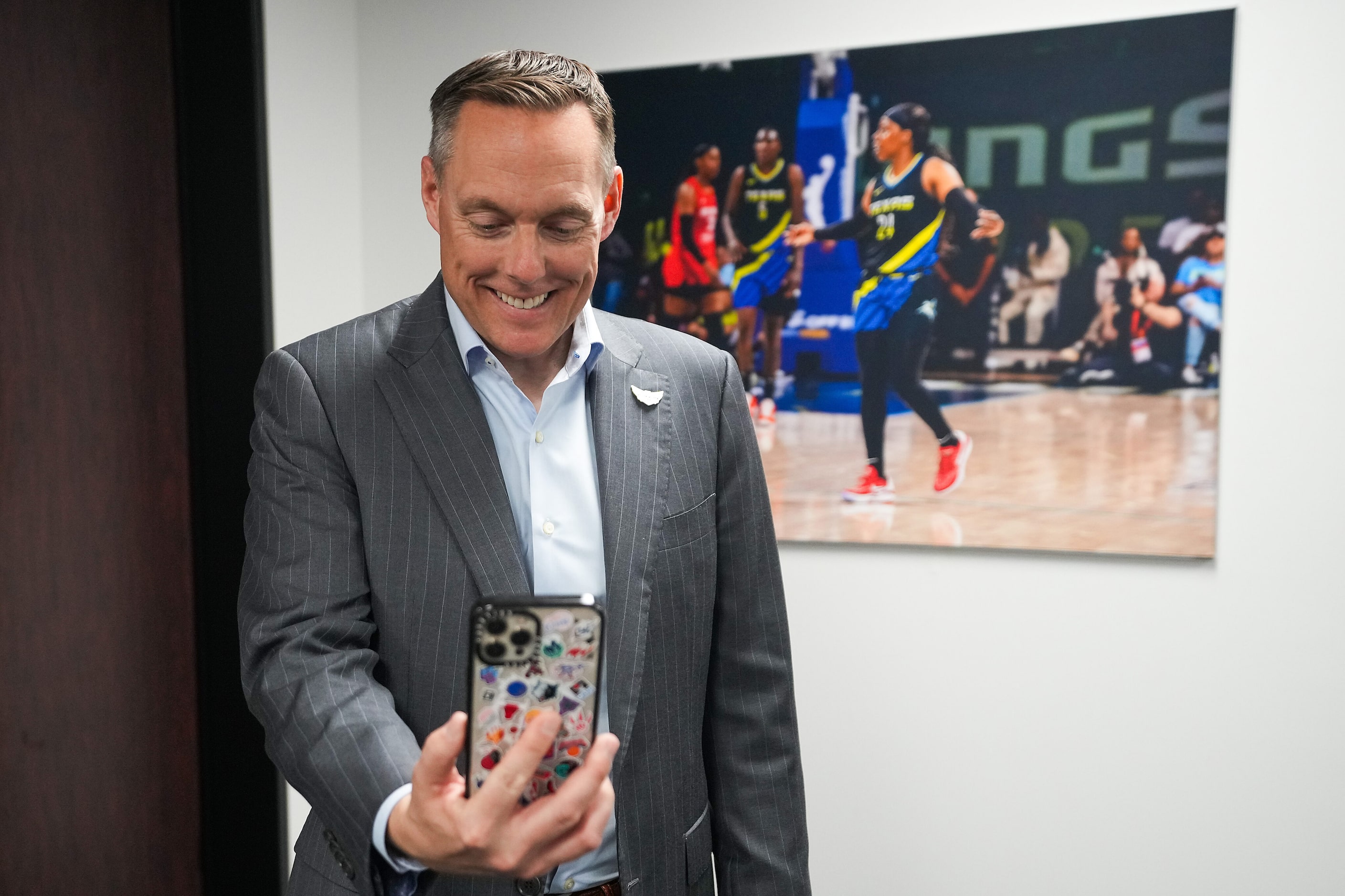 Dallas Wings President and CEO Greg Bibb reacts as he talks with first round pick Jacy...